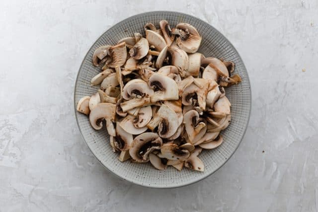 Bowl of sliced mushrooms to use in the puff pastry