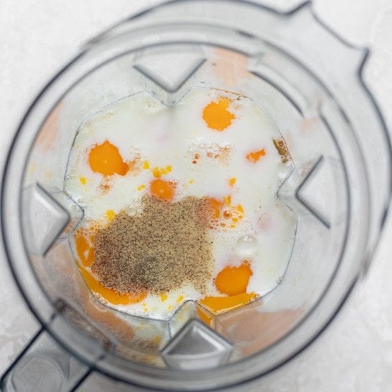 Seasonings and milk added to the blender with the eggs.