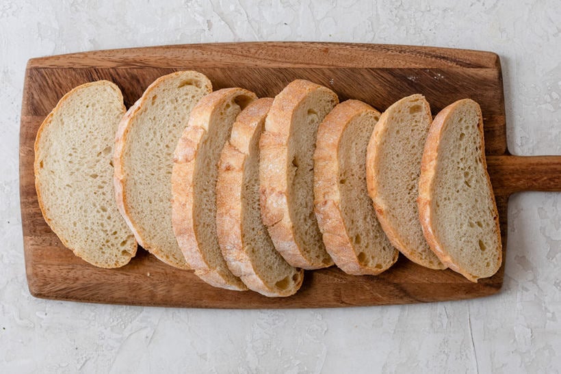 Sliced bread on cutting board ready to make french toast