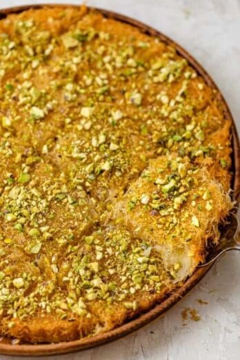 Lebanese kanafa cut into squares on a round dish