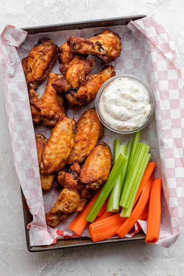 Air fryer chicken wings served with celery, carrots and ranch dressing