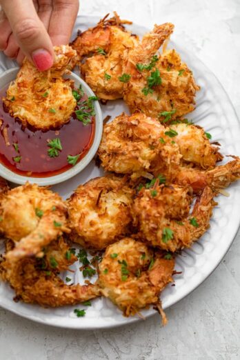 Dipping coconut shrimp in the sweet chili sauce