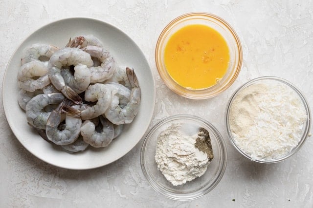 Ingredients to make recipe: shrimp, eggs, flour, panko and shredded coconut