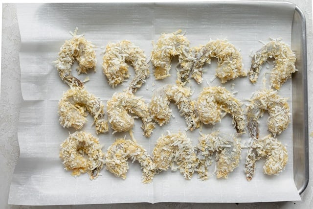 Breaded shrimp on a tray before getting cooked