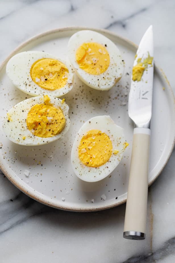 Air Fryer hard boiled eggs sliced in half with salt and pepper