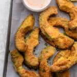 Avocado fries on a tray with spicy mayo sauce