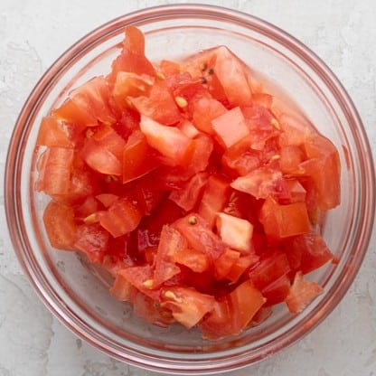 Cut tomatoes in a bowl.