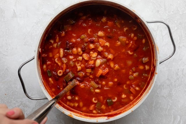 Large pot of the minestrone soup recipe with ladle in pot for serving