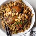 Freekeh with chicken served with toasted nuts and herbs