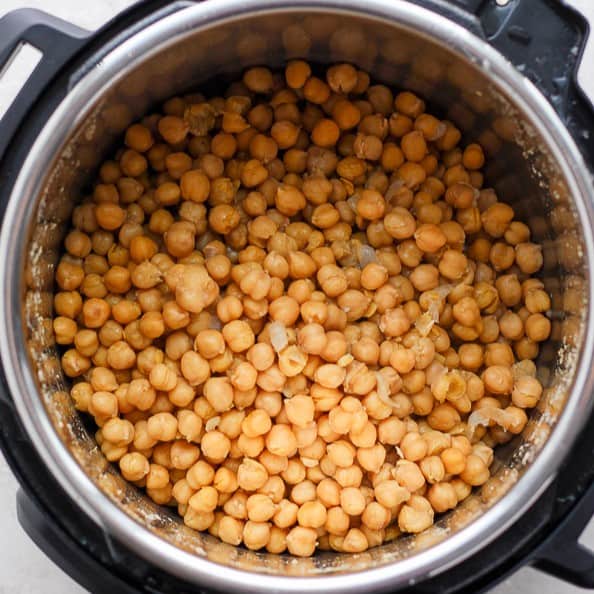 Cooked chickpeas in pressure cooker after the water is drained.