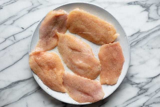 Thin cutlets of chicken breast dried and seasoned with salt and pepper