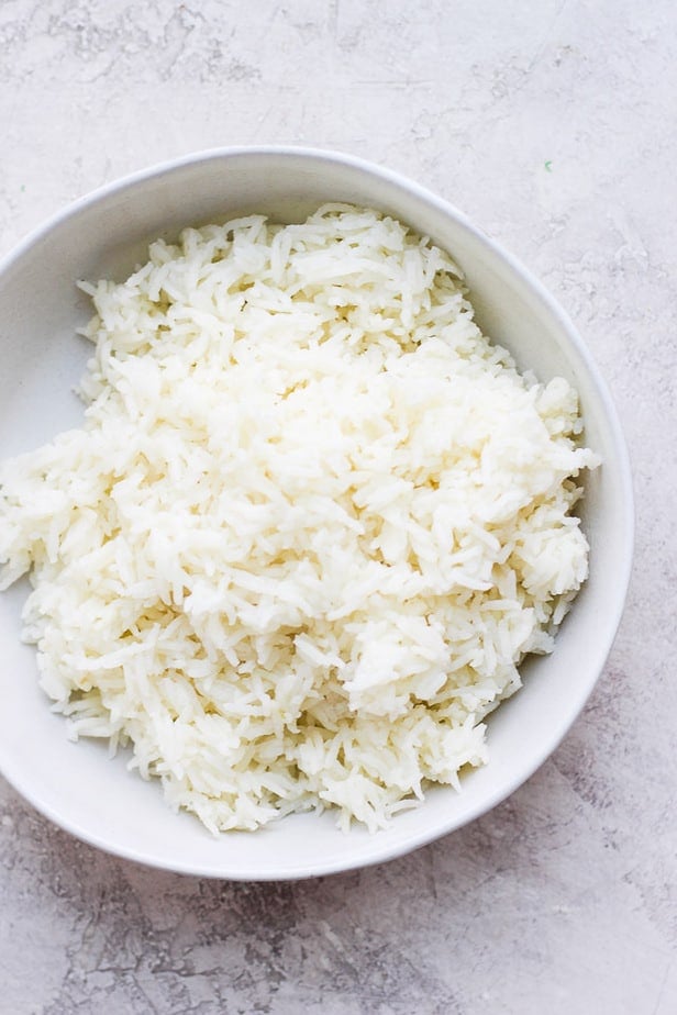 top down shot of white rice in a white bowl on a table