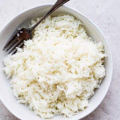White rice with a fork in a bowl