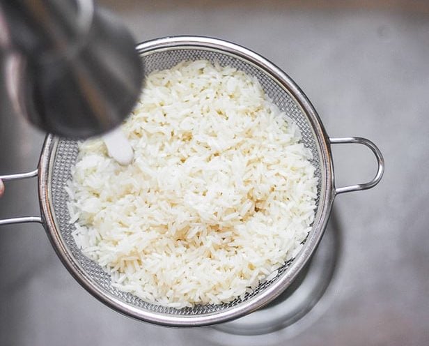 Rinsing white rice in aa sink