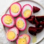 Beet pickled eggs on a plate with beets