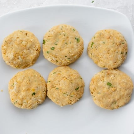 Fritters formed on a plate.