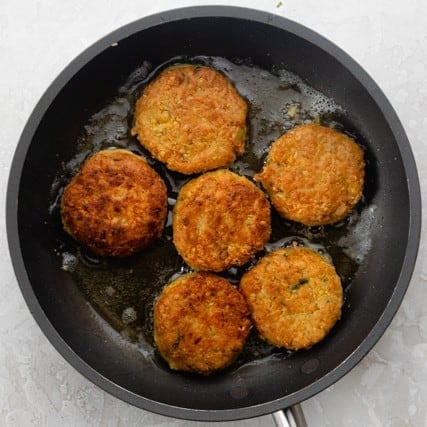 Fritters on a skillet before cooking.
