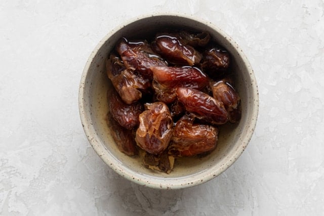 Soaking dates in warm water to soften them