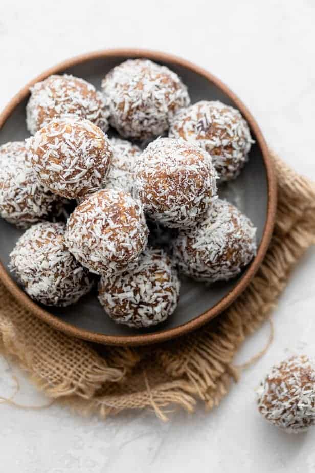 Coconut date balls in a shallow bowl
