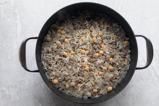 The broth added to the beef, onions and chickpeas