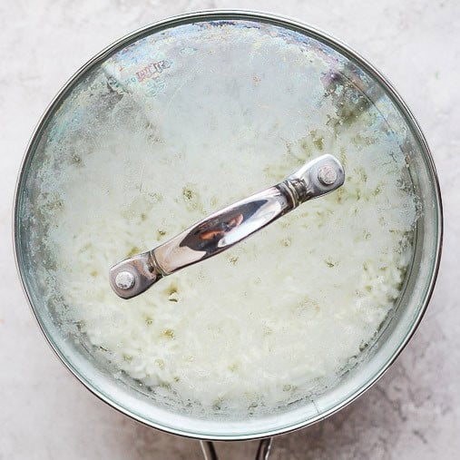 Saucepan covered towards end of cooking when it’s steaming.
