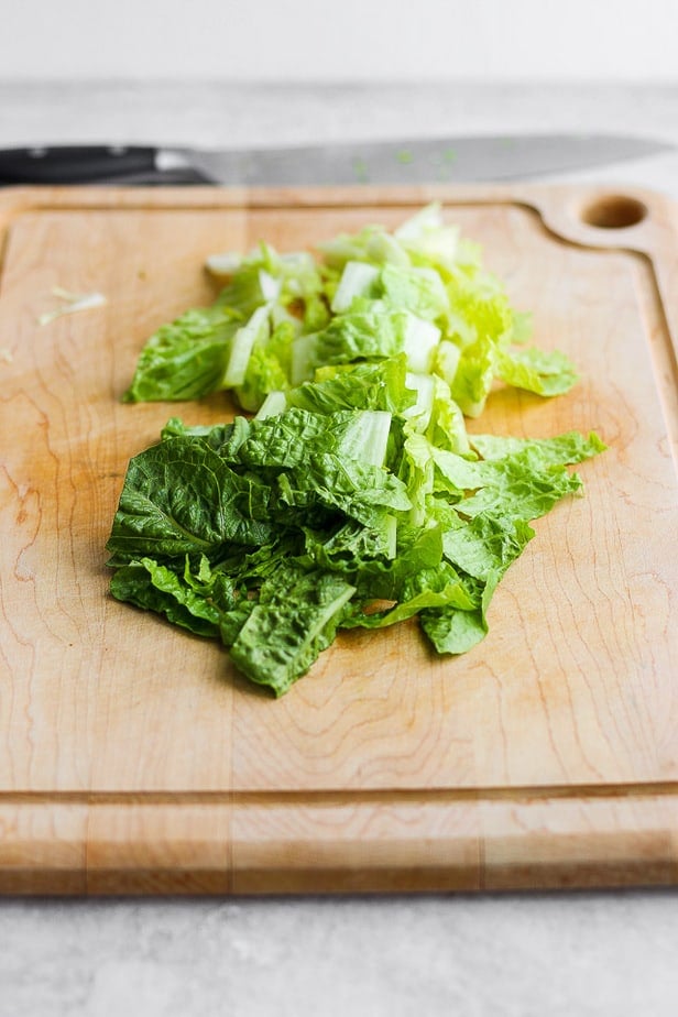 side shot of chopped lettuce on a chopping board