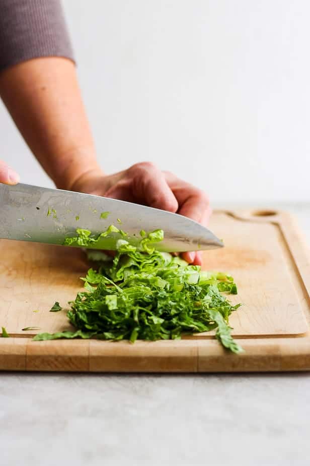 hand chopping lettuce