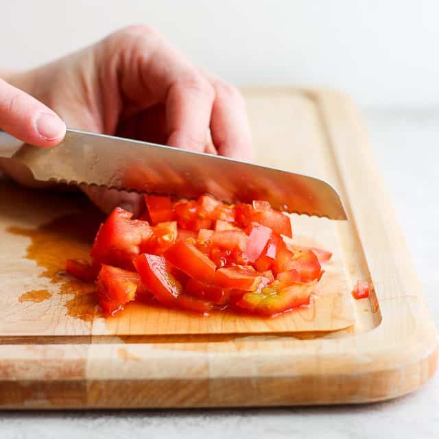side shot of dicing a tomato
