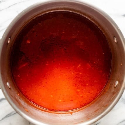 Tomato broth in pot.