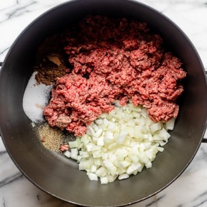 Stuffing ingredients in pot before cooking.