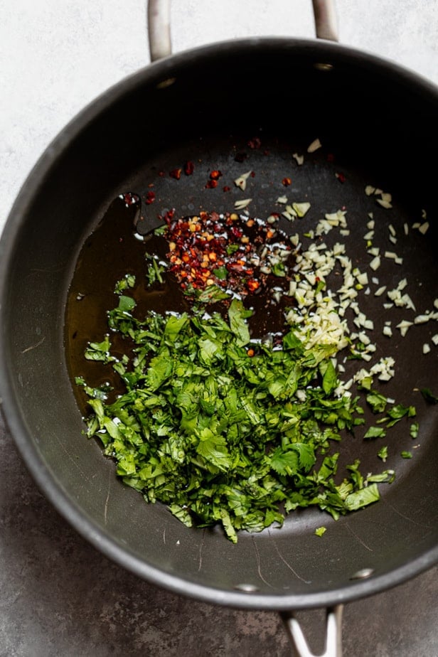 Herbs and spices cooking in a skillet