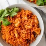 Bowl of Mexican chicken and rice served with cilantro