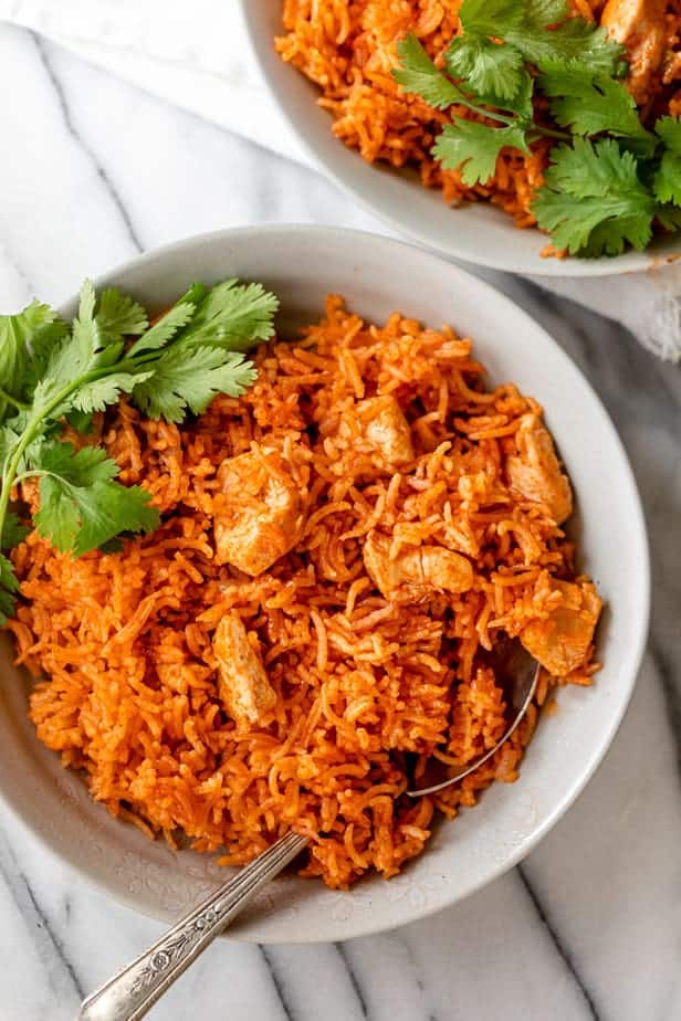 Bowl of Mexican chicken and rice served with cilantro