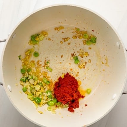 Sautéed green onions and ginger with added garlic and red curry paste.