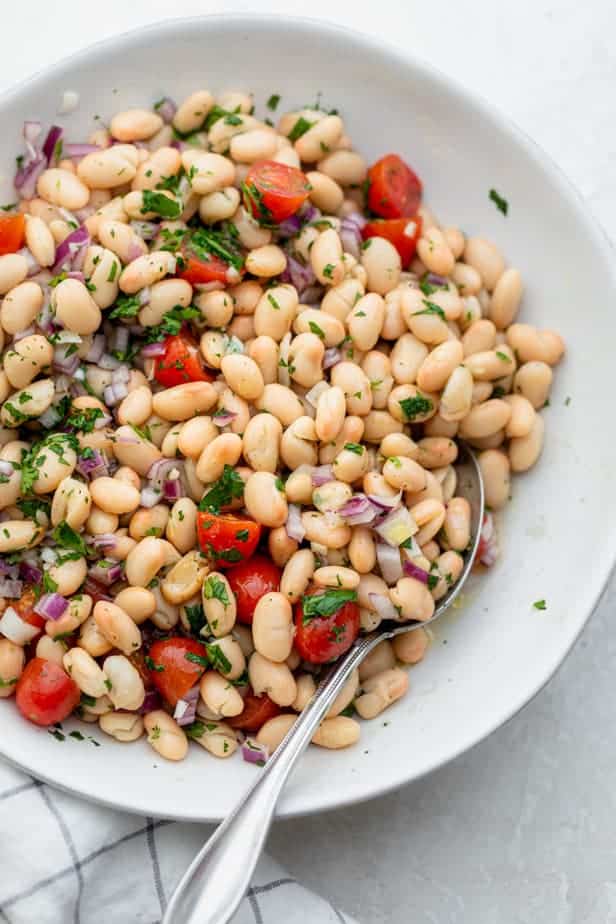 White bean salad in a white bowl