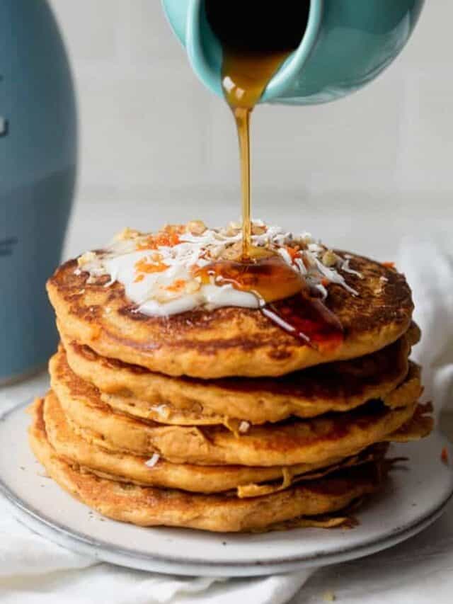 Carrot cake pancakes with maple syrup pouring on top