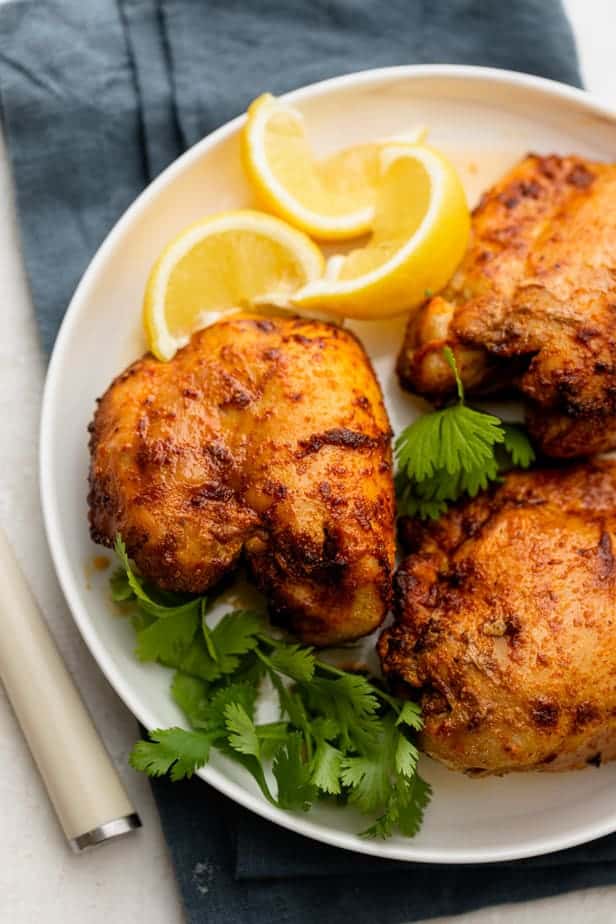 Air fryer chicken thighs on a white plate