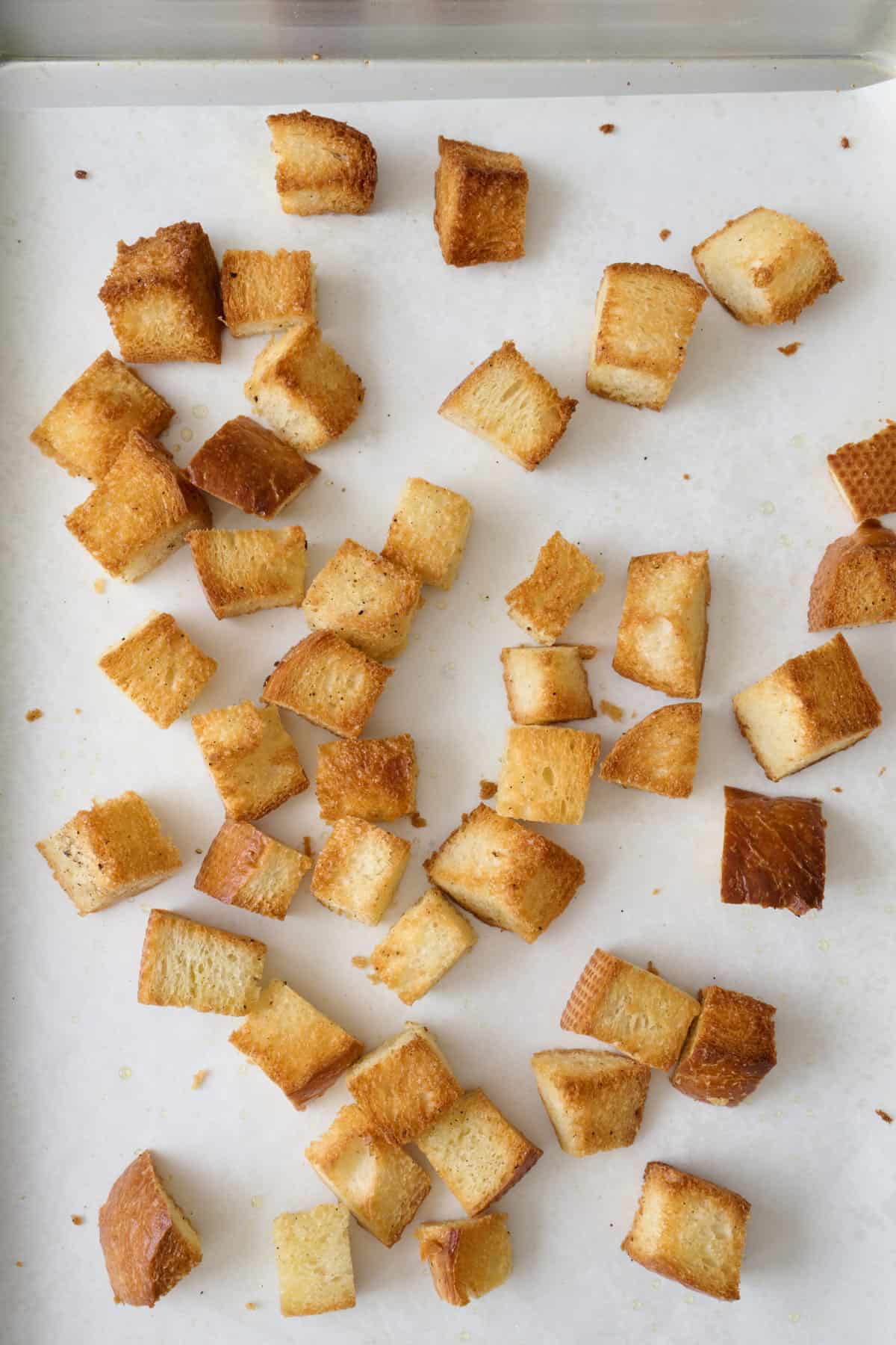 Homemade croutons after baking on a sheet pan.