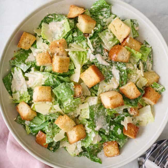 Caesar salad with croutons in a bowl.