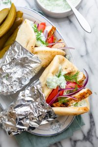 Two chicken gyros with veggies and tzatziki