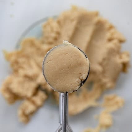 Scooping the dough with a cookie scoop.