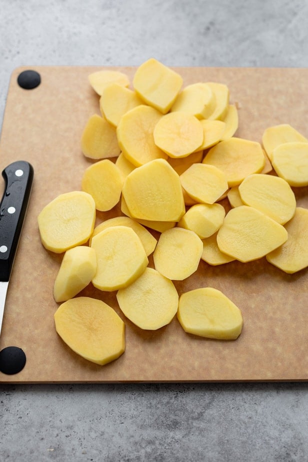 Sliced potatoes on a chopping board