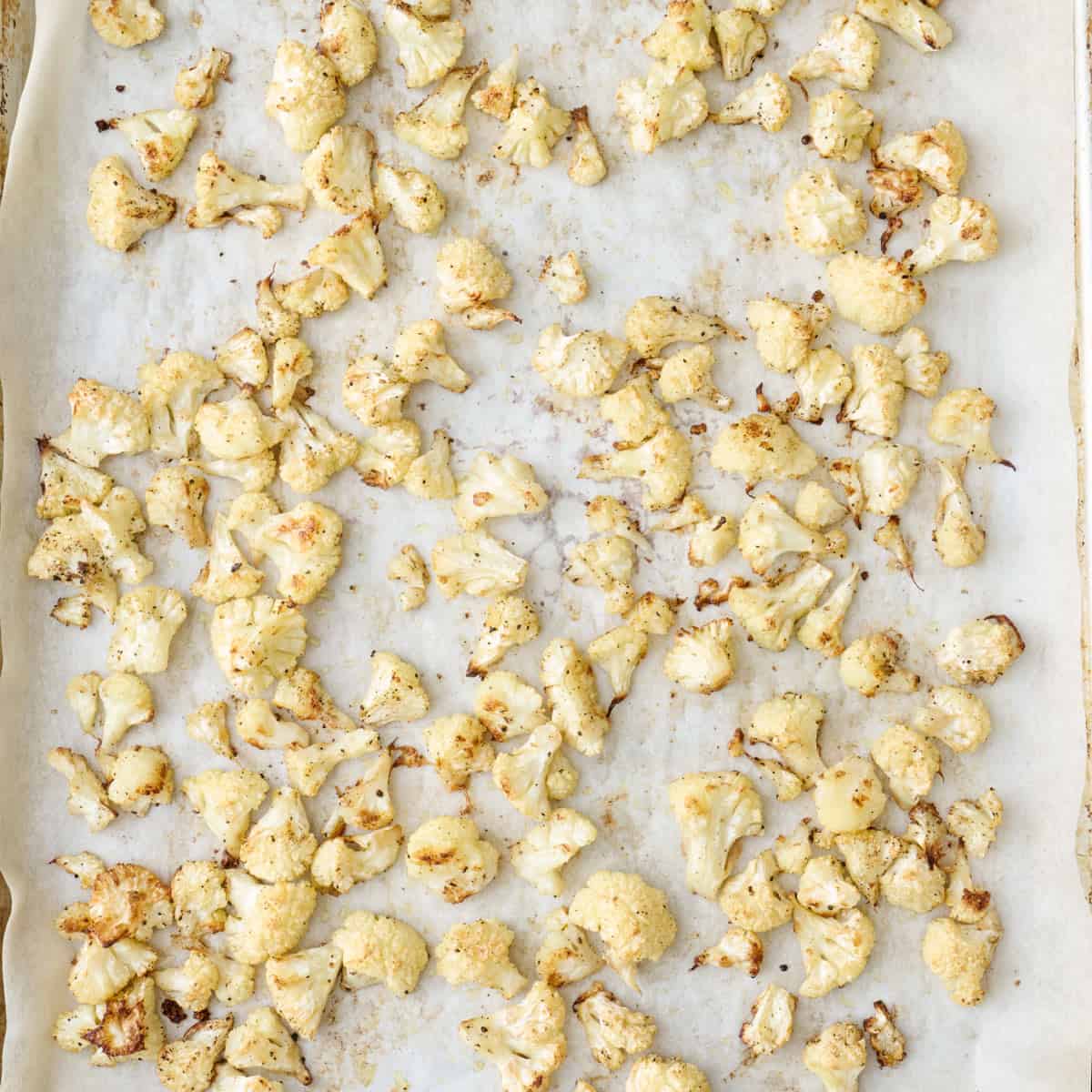 Cauliflower on a baking sheet after roasting.