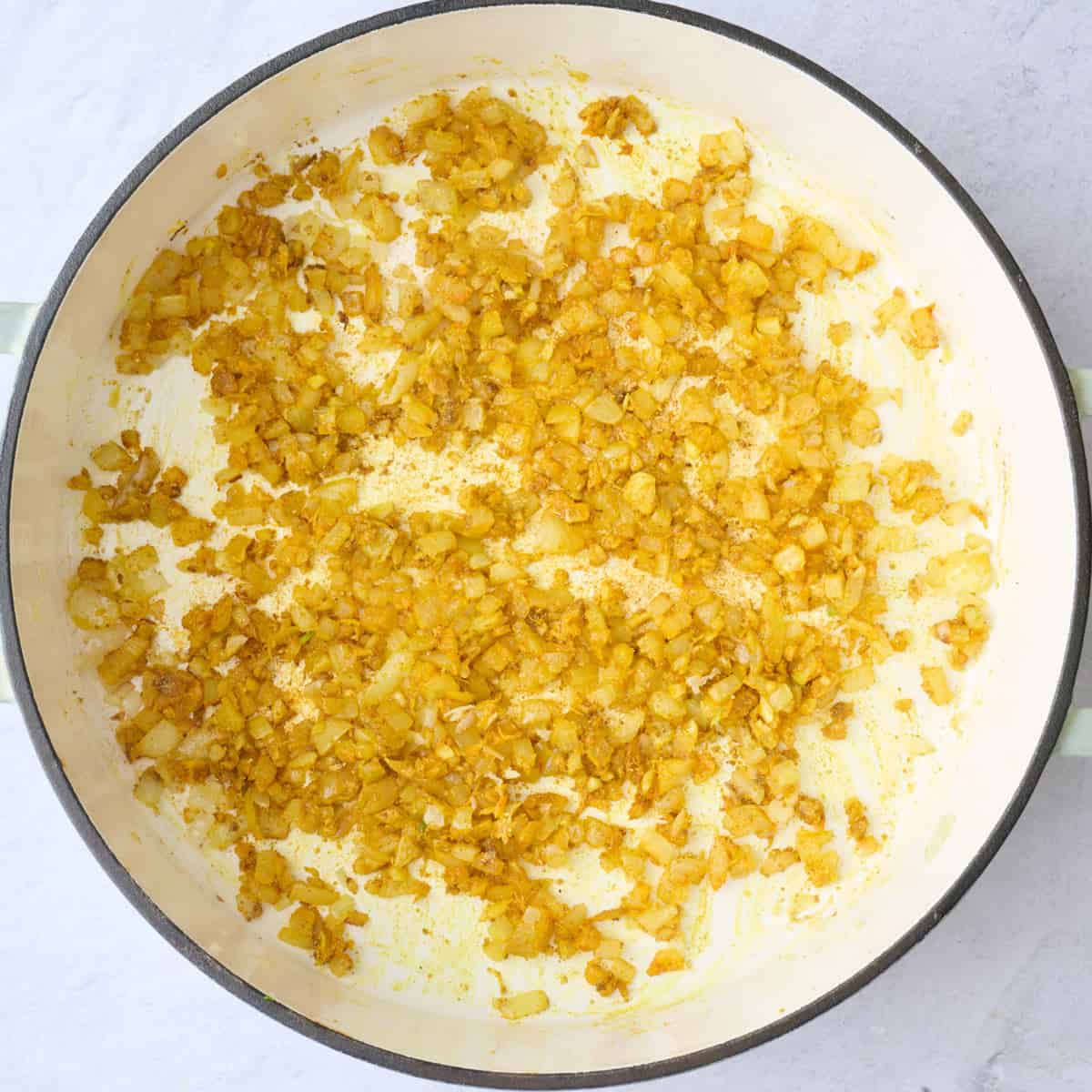 Onion, garlic, ginger, and seasonings in a large pot after cooking down.