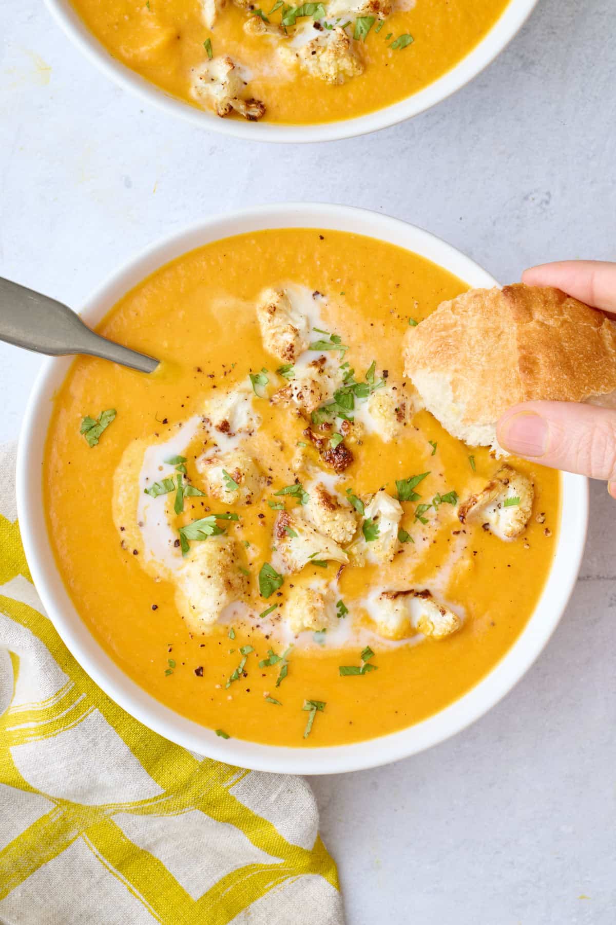One bowl with bread dipped into soup.