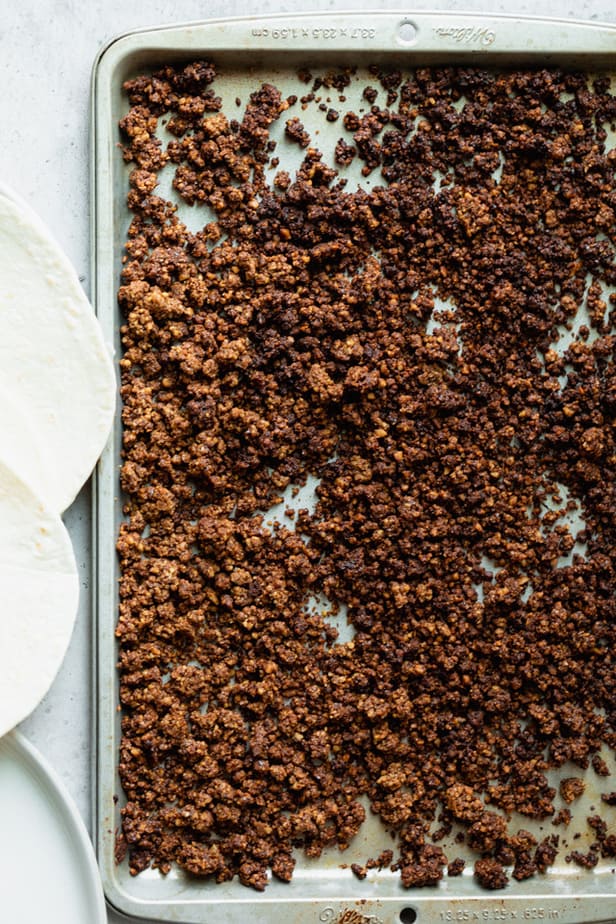 The cooked walnut mixture on a baking sheet