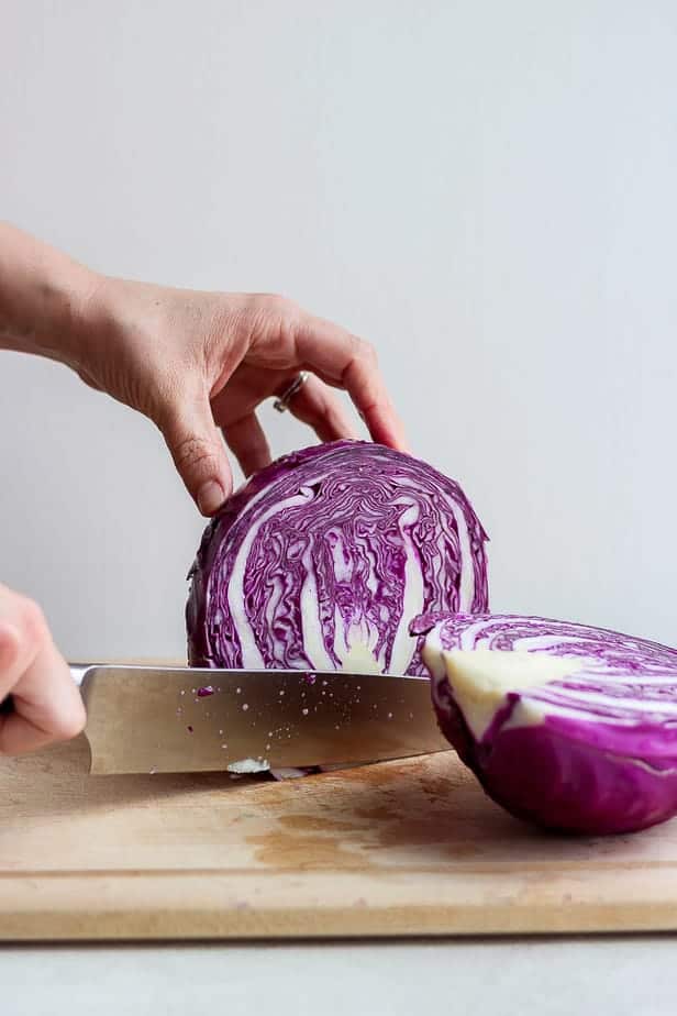 Tutorial for how to cut cabbage, showing cabbage sliced in half