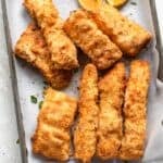 A baking sheet with pieces of air fried cod.