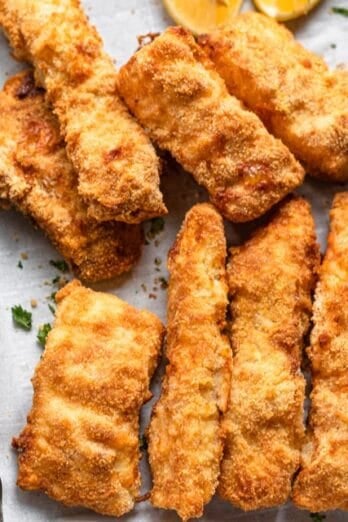 A baking sheet with pieces of air fried cod.