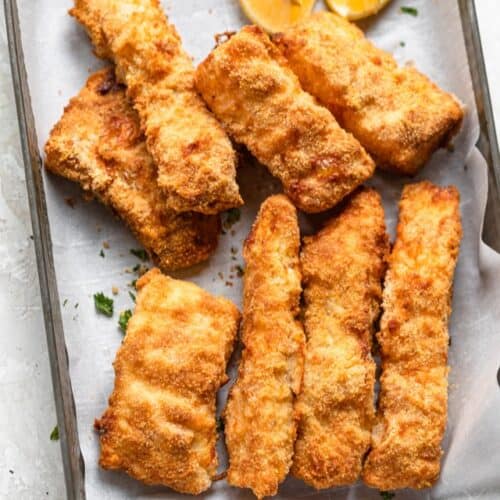 A baking sheet with pieces of air fried cod.